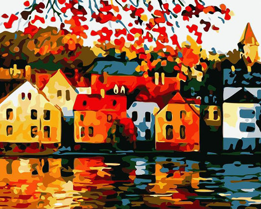 Colorful painting of houses by a lake with autumn leaves.