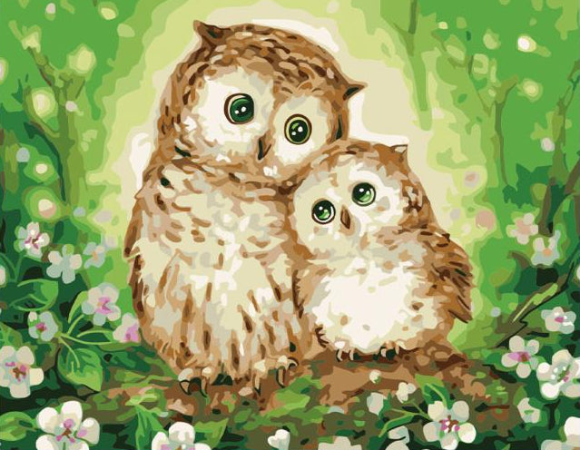 Canvas with two owls in a forest scene, surrounded by paint cans and a brush on a wooden floor.